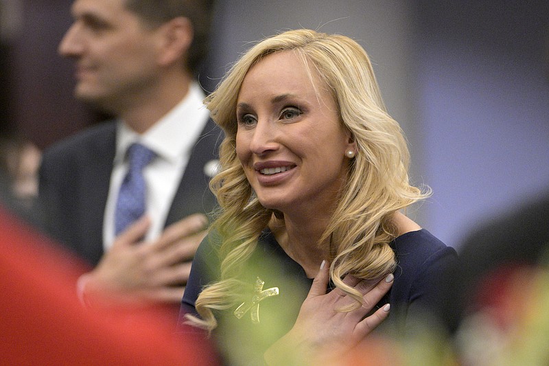 Florida Sen. Lauren Book stands for the Pledge of Allegiance during a legislative session, Tuesday, Jan. 11, 2022, in Tallahassee, Fla.  Book says she was extorted by someone threatening to reveal nude photos that were stolen from her. She&#x2019;s sponsoring a bill making it a felony to steal sexually explicit images from digital devices. (AP Photo/Phelan M. Ebenhack)