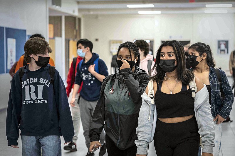 FILE - White Plains High School students walk between classes in White Plains, N.Y., April 22, 2021. The New York State Education Department is telling schools to continue to require masks despite a judge&#x2019;s ruling overturning the state's mask mandate. &#xa0;But some school districts already are rushing to drop the requirement. &#xa0;The Education Department said in a statement Tuesday, Jan. 25, 2022 that the state was appealing the ruling, which could temporarily halt it, and that schools should follow the mask rule in the meantime. (AP Photo/Mark Lennihan, File)