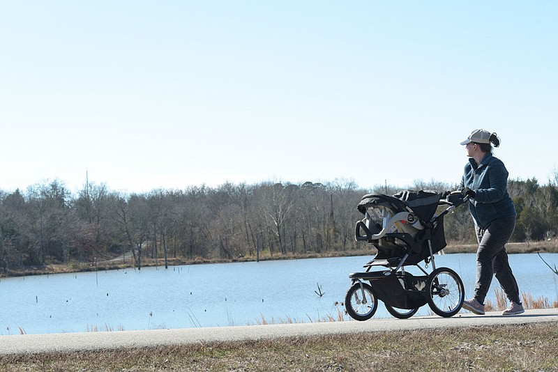 Elizabeth Watters of Fort Smith walks her three-month-old son Patrick around Torraine Lake on Tuesday, Jan. 25, 2022, in Fort Smith. At its meeting Tuesday night, the Sebastian County Quorum Court was due to review budget proposals, one of which entails a request for $93,069 for a prefab restroom and utility setup for the Torraine Lake area, which is part of Sebastian County's Ben Geren Park. Visit nwaonline.com/220126Daily/ for today's photo gallery.
(NWA Democrat-Gazette/Hank Layton)