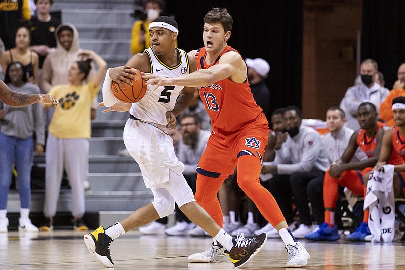 Auburn's Walker Kessler, right, tries to steal the ball from Missouri's Jarron Coleman, left, during the first half of an NCAA basketball game Tuesday in Columbia, Mo. – Photo by L.G. Patterson of The Associated Press