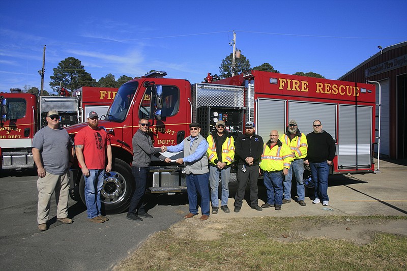 From left, Paul Love, Willie Anderson, Will Topf with Emergency Vehicle Specialists, Norphlet Mayor Jim Crotty, Norphlet Fire Chief Sonny Harper, Firefighter and Union County Coronor Stormey Primm, Firefighter Joey Cates, Firefighter Alan Williams and Lieutenant Anthony Harris stand beside Norphlet Fire and Rescue’s new truck, which was delivered on Wednesday. (Matt Hutcheson/News-Times)