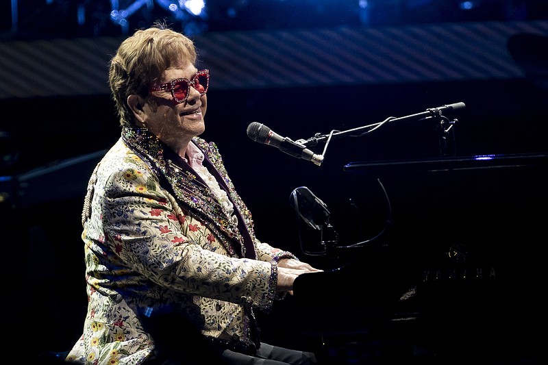 FILE - Elton John performs during his &quot;Farewell Yellow Brick Road&quot; tour on Wednesday, Jan. 19, 2022, in New Orleans.  Despite being vaccinated and boosted, John has contracted COVID-19 and is postponing two farewell concert dates in Dallas.  John &#x201c;is experiencing only mild symptoms,&#x201d; according to a statement. (AP Photo/Derick Hingle, File)