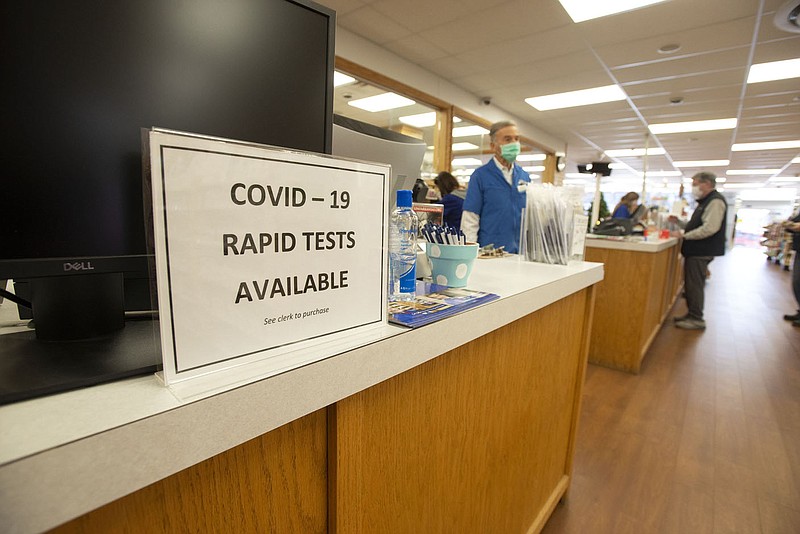 Covid-19 tests are advertised at Collier Drug on Dickson Street in Fayetteville on Jan. 13, 2022. The city's Board of Health discussed the potential timeline of the omicron surge during its meeting on Wednesday, Jan. 26, 2022. (File photo/NWA Democrat-Gazette/J.T. Wampler)