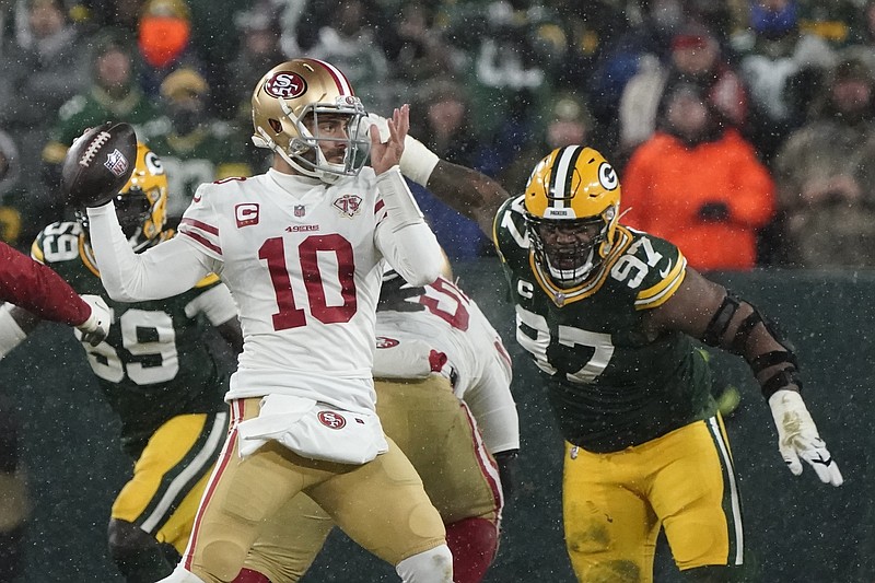 San Francisco 49ers' Jimmy Garoppolo thorws with Green Bay Packers' Kenny Clark rushing during the second half of an NFC divisional playoff NFL football game Saturday, Jan. 22, 2022, in Green Bay, Wis. (AP Photo/Morry Gash)