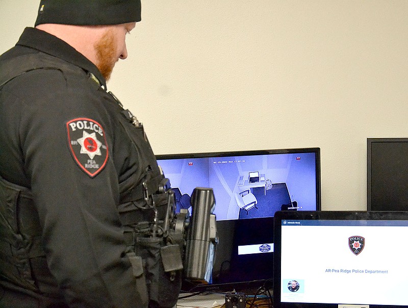Pea Ridge Police Officer Justin Lawson recently showed how he transfers the video from the camera to the computer in the office.