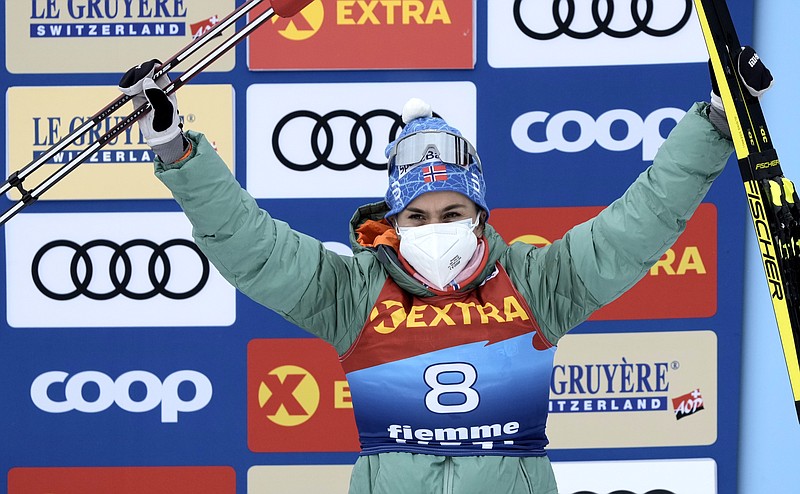 Norway's Heidi Weng celebrates on the podium after winning the women's Mass Start Free 10km event at the Tour de Ski in Val di Fiemme, Trento, Italy, on Jan. 4. Two members of Norway’s women’s cross-country team, Heidi Weng and Anne Kjersti Kalvaa, have tested positive for the coronavirus ahead of next month's Beijing Olympics. They contracted COVID-19 at a training camp in the Italian Alpine resort of Seiser Alm and are now isolating. – Photo by Giovanni Auletta of The Associated Press