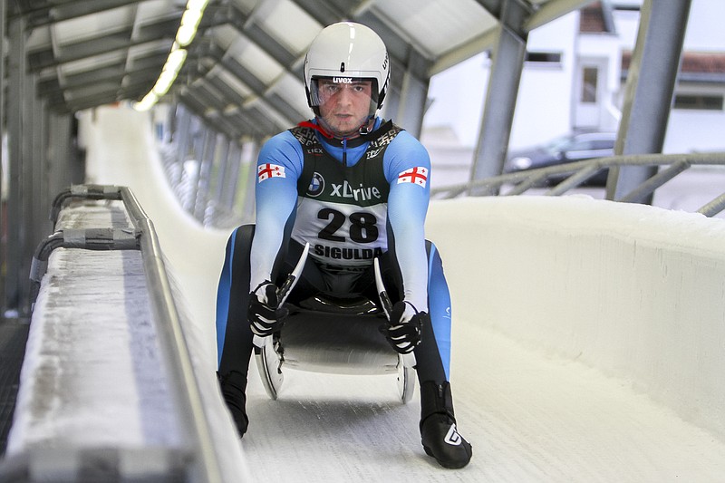 Saba Kumaritashvili of Georgia has his photo taken before speeding down the track during a men's race at the 52th FIL Luge European Championships in Sigulda, Latvia, on Jan. 7, 2021. Kumaritashvili will compete in luge next month at the Beijing Olympics, 12 years after his cousin Nodar Kumaritashvili died in a training accident at the Vancouver Games. – Photo by Sandra Skutane of The Associated Press