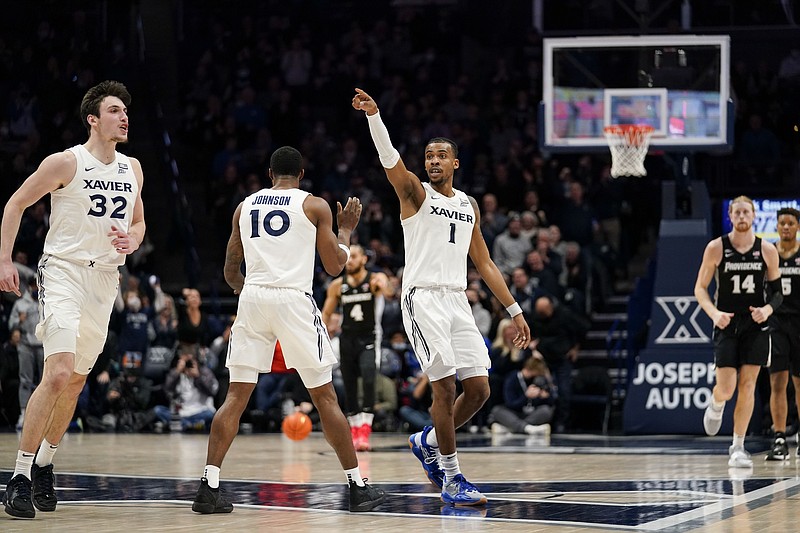 Xavier guard Paul Scruggs (1) reacts after scoring a three-point shot during the second half of an NCAA basketball game against Providence Wednesday in Cincinnati. – Photo by Jeff Dean of The Associated Press