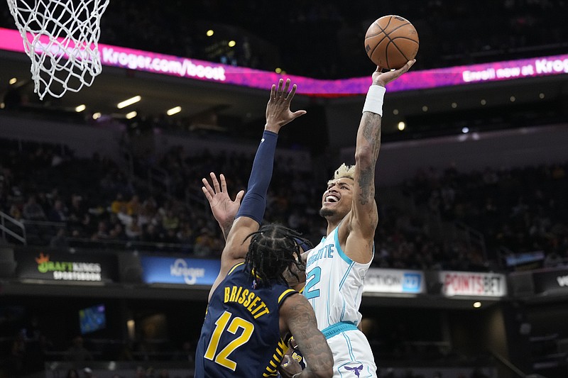 Charlotte Hornets guard Kelly Oubre Jr., right, shoots over Indiana Pacers forward Oshae Brissett during the first half of an NBA game in Indianapolis Wednesday. – Photo by AJ Mast of The Associated Press