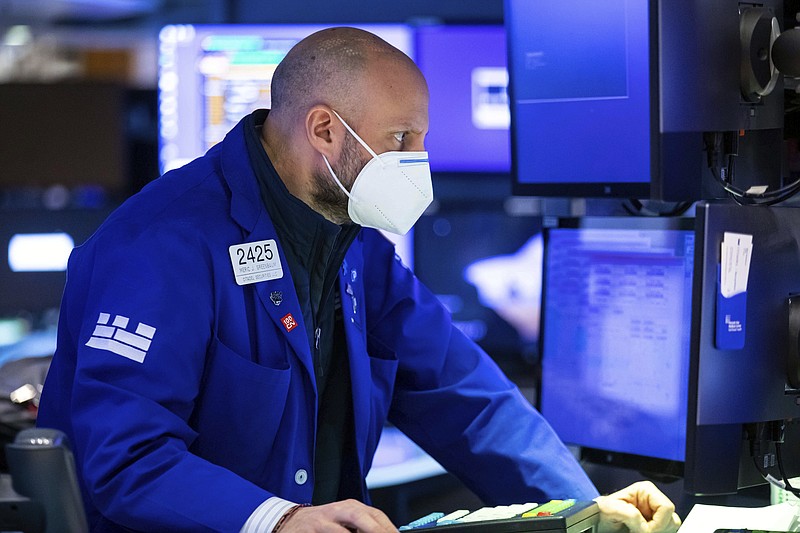 In this photo provided by the New York Stock Exchange, specialist Meric Greenbaum works at his post on the trading floor, Thursday, Jan. 27, 2022. Stocks gave up early gains and turned mixed in afternoon trading on Wall Street Thursday as markets struggle to settle down following several days of whiplash moves. (David L. Nemec/New York Stock Exchange via AP)