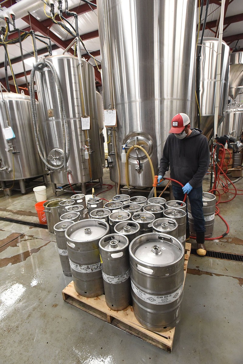 Reid Walker washes kegs at Ozark Beer Co. in Rogers on Wednesday Jan. 26 2022 after filling them with pale ale.
(NWA Democrat-Gazette/Flip Putthof)