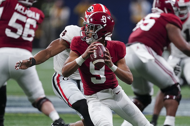 FILE - Alabama quarterback Bryce Young (9) works against Georgia during the second half of the Southeastern Conference championship NCAA college football game Dec. 4, 2021, in Atlanta. Alabama plays Georgia in the College Football Playoff national championship game on Jan. 10, 2022.(AP Photo/John Bazemore, File)