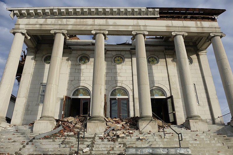 The damaged facade of the First United Methodist Church is seen on Jan. 9, 2022, in Mayfield, Ky. The century-old church has long been an anchor in the Kentucky town of about 10,000 residents, holding countless worship services, weddings, funerals and baptisms. That was before a deadly tornado swept through Mayfield in December, tearing off the church's roof and leaving rubble strewn across the entrance. (AP Photo/Audrey Jackson)