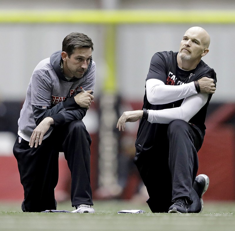 FILE - Atlanta Falcons head coach Dan Quinn, right, talks with offensive coordinator Kyle Shanahan during a workout at the NFL football team's practice facility in Flowery Branch, Ga., Friday, Jan. 27, 2017. Kyle Shanahan and Dan Quinn will always share the painful memory of coaching in the Super Bowl together with Atlanta five years ago when the Falcons couldn't hold a 25-point lead in the second half of a loss to New England. The wild-card meeting Sunday, Jan. 16, 2022 between the visiting 49ers (10-7) and Cowboys (12-5) is the first in the playoffs involving both coaches since that crushing loss in Houston.(AP Photo/David Goldman, File)