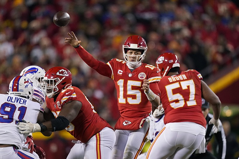 Kansas City Chiefs quarterback Patrick Mahomes (15) throws a pass during overtime in an NFL divisional round playoff football game against the Buffalo Bills, Sunday, Jan. 23, 2022, in Kansas City, Mo. The Chiefs won 42-36. (AP Photo/Charlie Riedel)