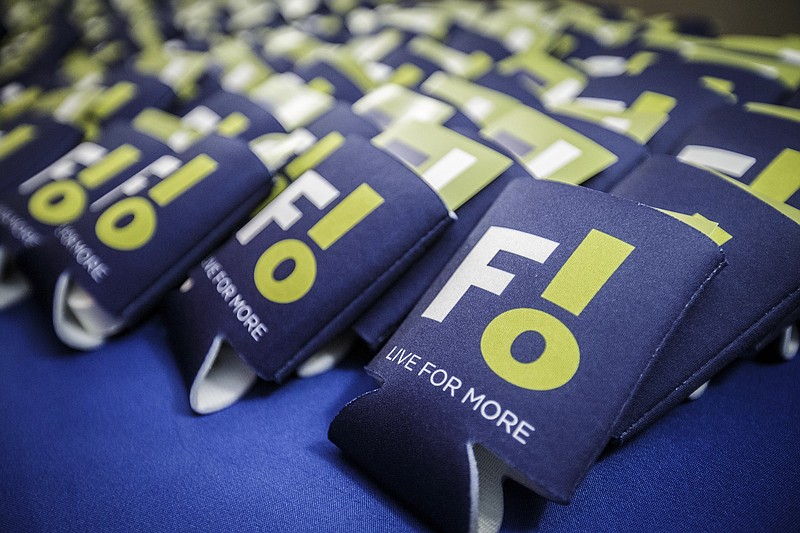 Beverage sleeves with the city of Florence's new logo sit out for guests to take home following a reveal at the Shoals Community Theatre, Tuesday, Jan. 25, 2022, in Florence, Ala. Some residents think the city's new logo might be sending the wrong message. (Dan Busey/The TimesDaily via AP)