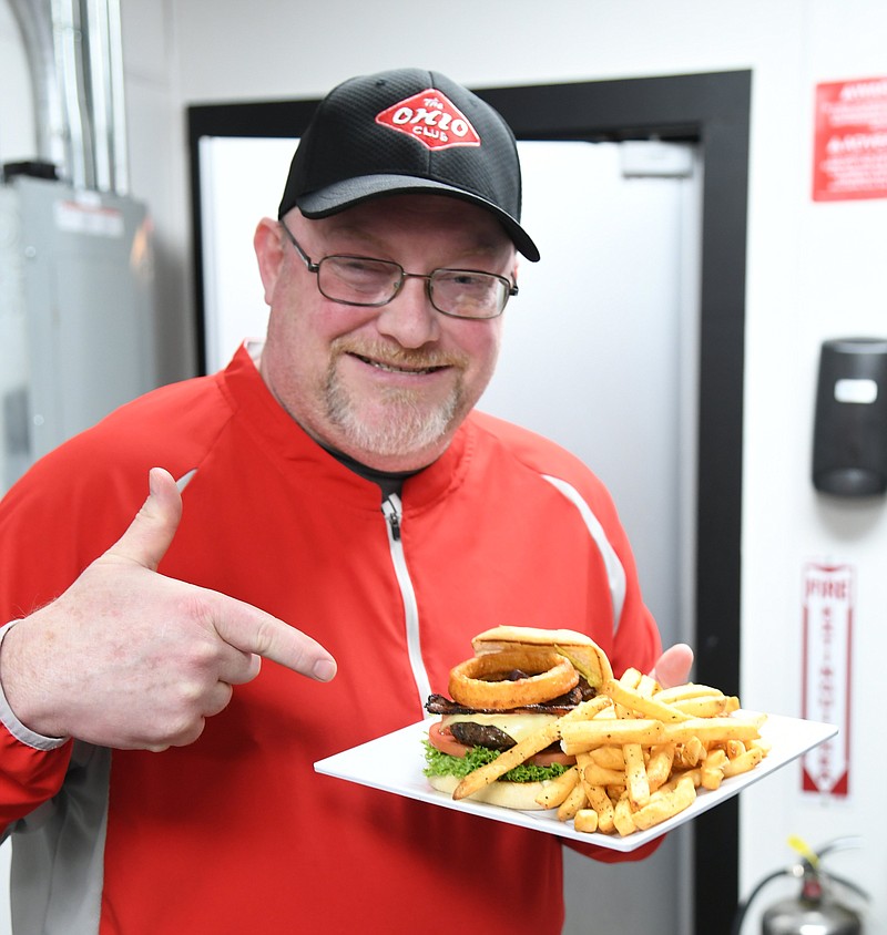 Michael “The Burger Chef” Dampier displays a burger at The Ohio Club. - Photo by Tanner Newton of The Sentinel-Record