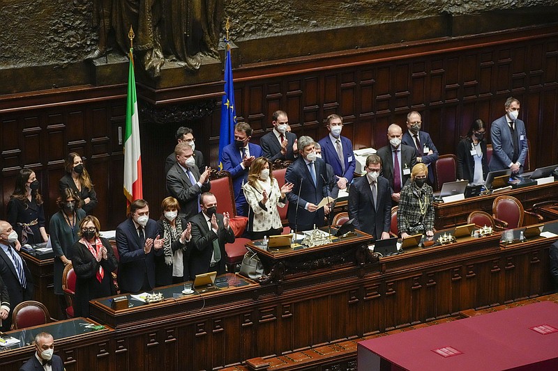President of the Senate Maria Elisabetta Alberti Casellati, center left, and lawmakers applauded as low Chamber President Roberto Fico, center right, announces that Sergio Mattarella is re-elected as Italy's 13th president in the Italian parliament in Rome, Saturday, Jan. 29, 2022, at the end of the eighth round of voting. (AP Photo/Gregorio Borgia, Pool)