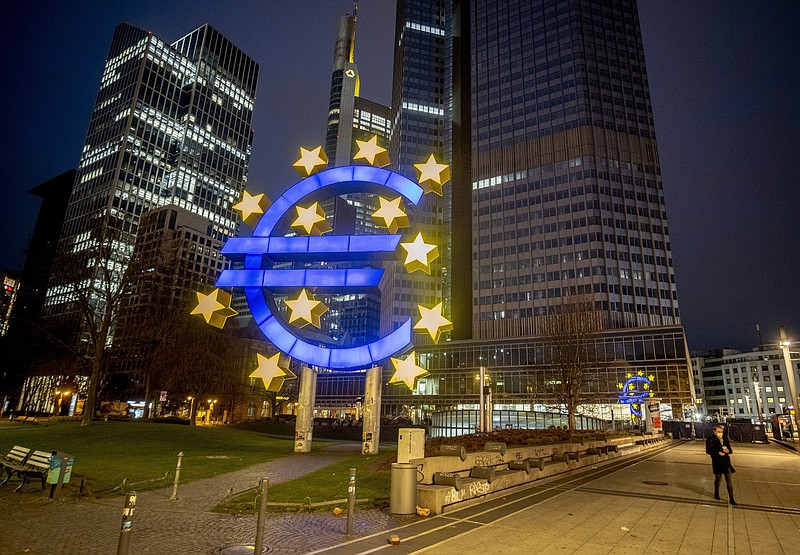 FILE - A man walks past the Euro sculpture in Frankfurt, Germany, March 11, 2021. Growth in the 19 European Union countries that use the euro slowed down in the last three months of 2021. The European Union statistics agency said Monday, Jan. 31, 2022 that it was at 0.3%, down from 2.2% recorded in the July-September quarter. (AP Photo/Michael Probst, File)
