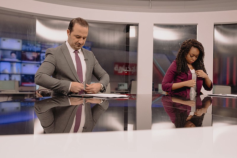 Randa Abd Al-Aziz, right, and a co-host prepare for a news segment at a state television studio in Baghdad, Iraq, Jan. 21, 2022. Abd Al-Aziz is the first Black Iraqi employed on-air at the state television’s news and information channels at least since the U.S. toppled Saddam Hussein almost two decades ago — and possibly the first ever. (Aline Deschamps/The New York Times)