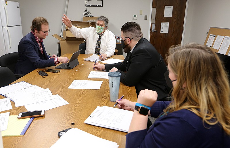Public defender Lou Marczuk (left center) leads a pretrial conference with other public defenders on Wednesday, Feb. 2, at the Pulaski County Administration building in Little Rock. (Arkansas Democrat-Gazette/Thomas Metthe)