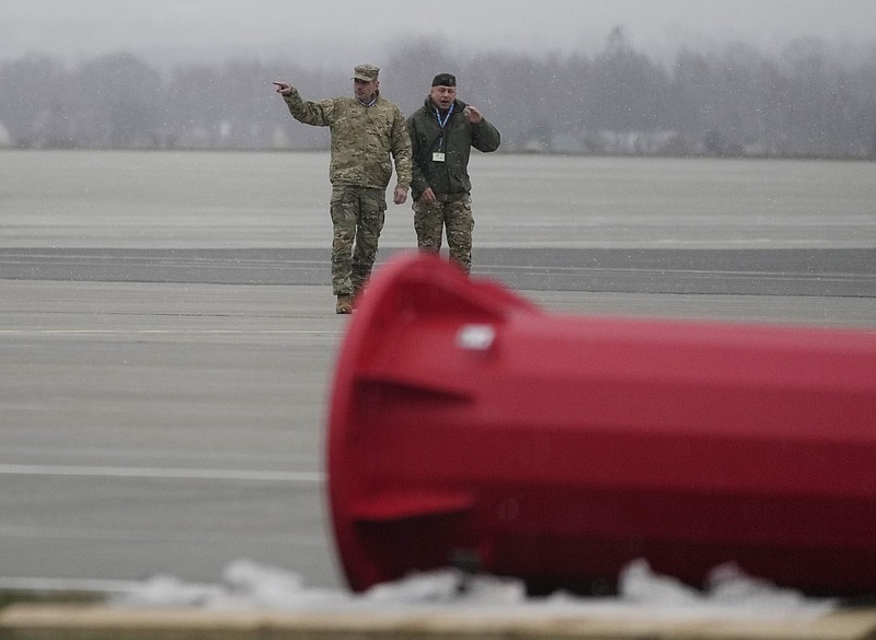 Polish and U.S. Army officers of the 82nd Airborne Division talk after unloading vehicles from a transport plane after arrived from Fort Bragg, at the Rzeszow-Jasionka airport in southeastern Poland, Sunday, Feb. 6, 2022. Additional U.S. troops are arriving in Poland after President Joe Biden ordered the deployment of 1,700 soldiers here amid fears of a Russian invasion of Ukraine. Some 4,000 U.S. troops have been stationed in Poland since 2017. (AP Photo/Czarek Sokolowski)