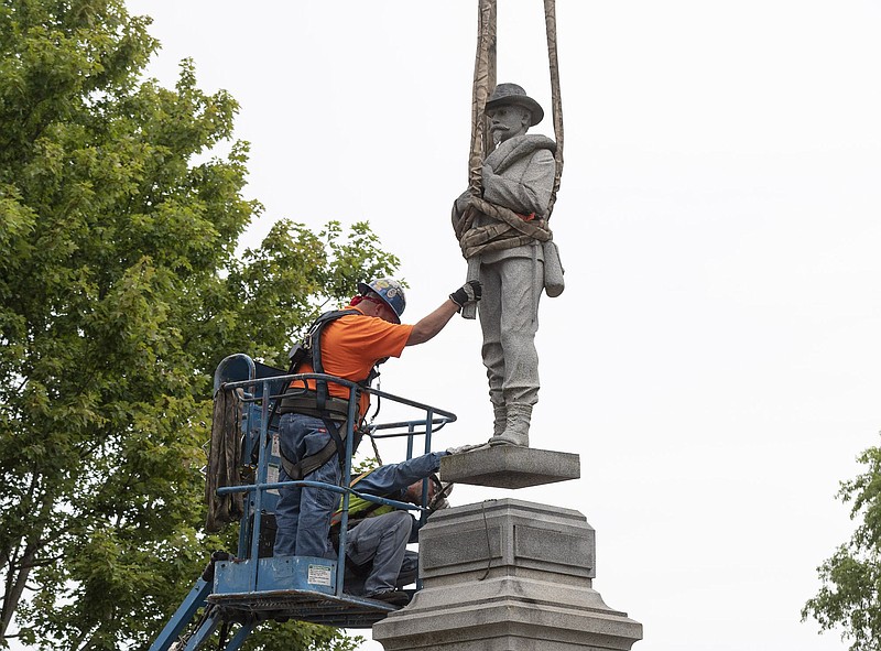Workers from Nabholz Construction work Tuesday, September 2, 2020 to remove the confederate statue from the Bentonville square.  (NWA Democrat-Gazette FILE PHOTO/Spencer Tirey)