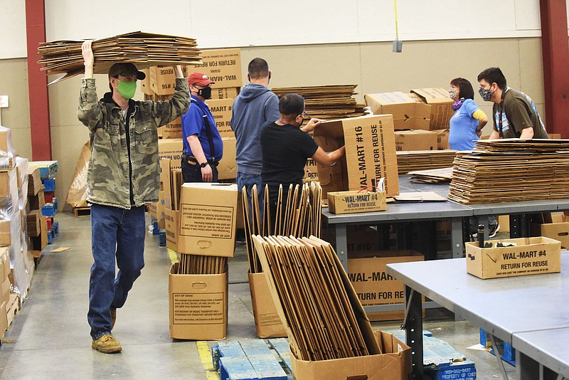 A crew gets boxes ready for use on Feb. 9 2022 at Open Avenues.
(NWA Democrat-Gazette/Flip Putthoff)