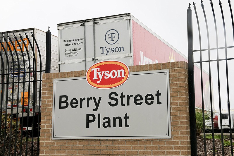 In this image from the Howard Center for Investigative Journalism at the University of Maryland's Philip Merrill College of Journalism, a Tyson Berry Street Plant sign is seen in front of the Springdale, Arkansas, Tyson parking lot for hauling chicken products, April 20, 2021. The Berry Street location had more than 400 COVID-19 cases among the workers, the highest number of cases across Arkansas poultry plants. (Abby Zimmardi/University of Arkansas via AP)