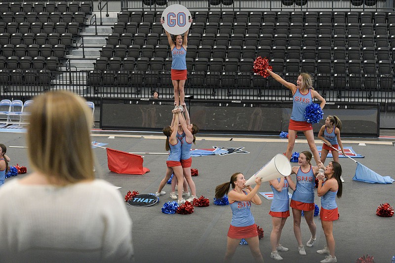 Hannah Graham (left), coach of the Fort Smith Southside High School cheerleading team, conducts a squad practice. The cheer team claimed first place at the Universal Cheer Association's National High School Cheerleading Championship on Sunday after three consecutive years participating in the event. (NWA Democrat-Gazette/Hank Layton)