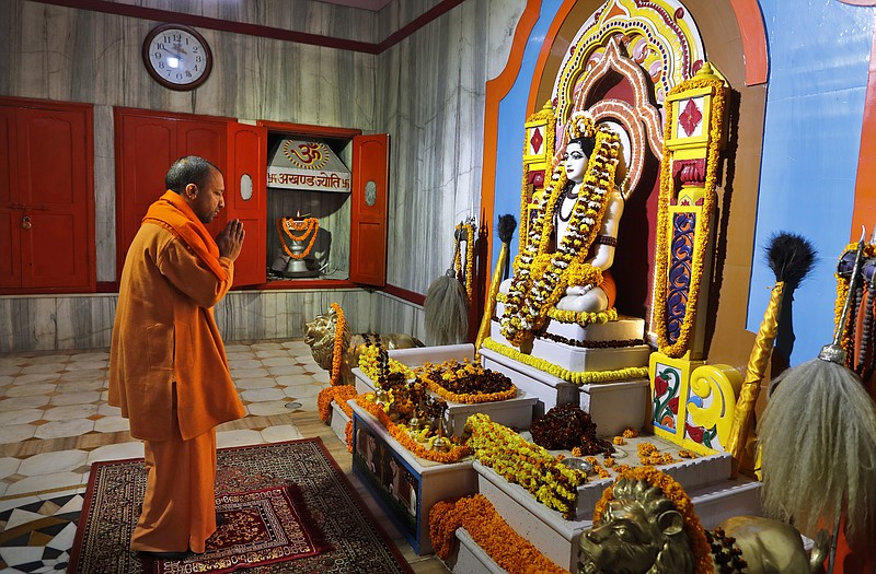 Uttar Pradesh Chief Minister Yogi Adityanath prays at a temple in the morning before going to file his nomination papers for the state assembly elections in Gorakhpur, India, Feb. 5, 2022. The polls are a referendum on the saffron-robed Adityanath, a poster figure for the Hindu right-wing, who some analysts believe is vying to be the next prime minister. Over 150 million people are expected to vote in the state across seven phases starting Thursday before results are declared in March. (AP Photo/Rajesh Kumar Singh)