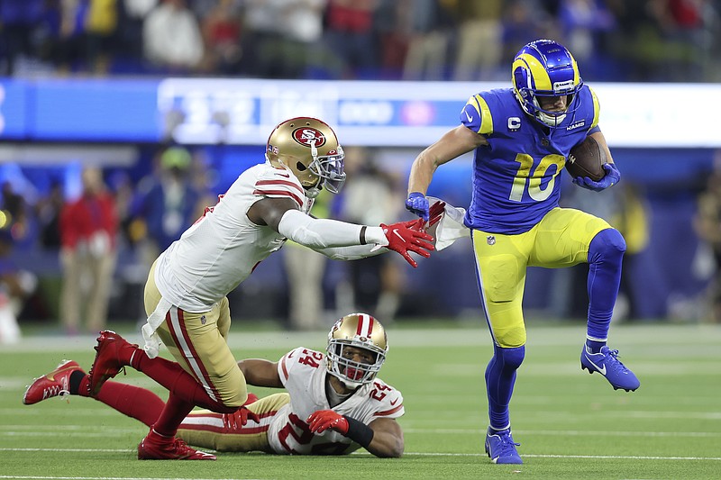 Los Angeles Rams' Cooper Kupp (10) gets past San Francisco 49ers' Jaquiski Tartt, left, and K'Waun Williams (24) during the second half of the NFC Championship NFL football game Sunday, Jan. 30, 2022, in Inglewood, Calif. (AP Photo/Jed Jacobsohn)
