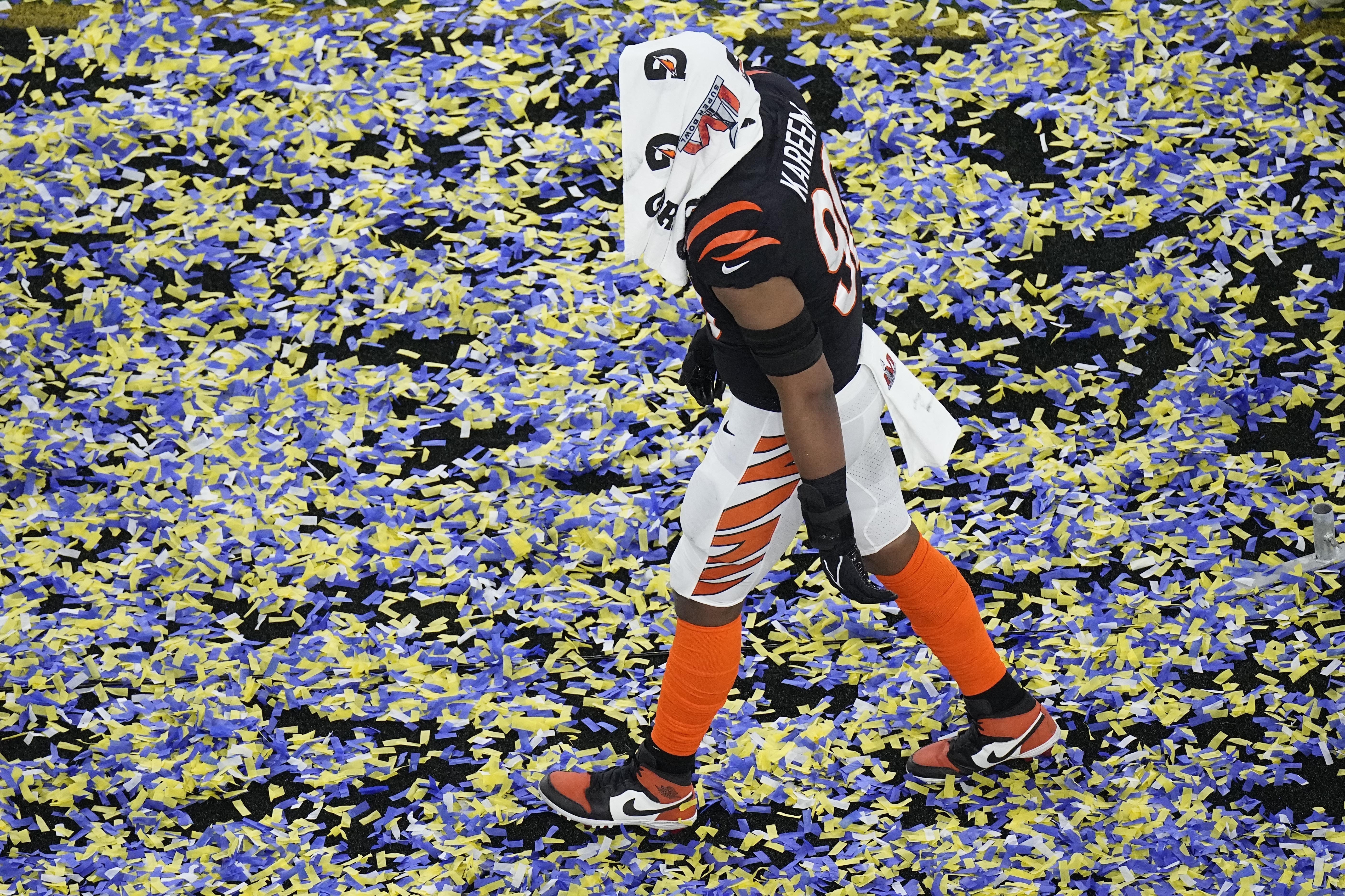 Cincinnati Bengals wide receiver Ja'Marr Chase, left, and tight end C.J.  Uzomah talk on the field after losing to the Los Angeles Rams in the NFL Super  Bowl 56 football game Sunday