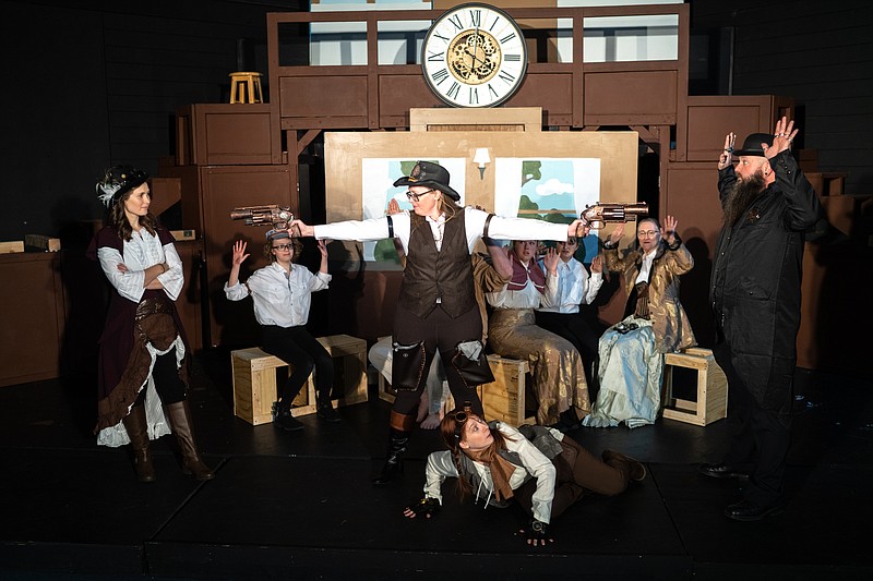 Ethan Weston/News Tribune Jennifer Kimlinger, center, holds up Mackenzie White, left, Dave Bond, right and other members of the cast of “Around the World in 80 Days” during play rehearsal on Thursday, Feb. 10, 2022, at Itsy Bitsy Broadway in the Capital Mall.