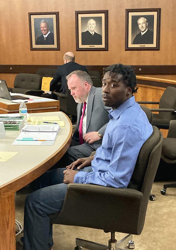 Capital murder defendant Kristopher "Flip" Wilson, in blue, sits next to his defense lawyer, Derric McFarland of Texarkana, on the first day of trial. Wilson is accused in the December 2020 death of Chase Porier. He faces life without parole if convicted as the state is not seeking the death penalty.