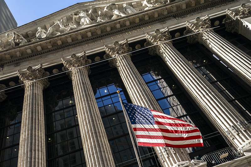 FILE - A U.S. flag waves outside the New York Stock Exchange, Monday, Jan. 24, 2022, in New York. Stocks are opening higher and crude oil prices are falling Tuesday, Feb. 15,  as investors welcomed early signs that tensions appear to be easing in Ukraine.  (AP Photo/John Minchillo, File)