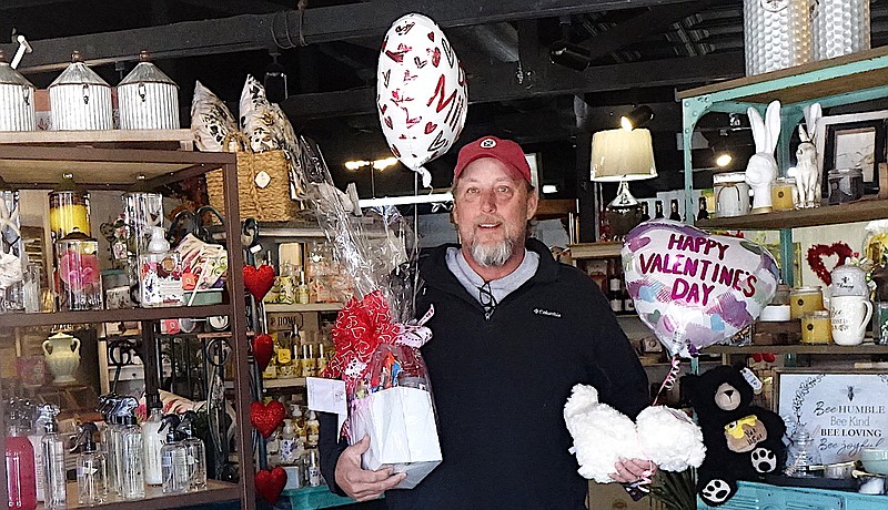 Doug Heath of Douglassville, Texas, knows what to do on Valentine’s Day. He gets flower and candy gifts from Atlanta Flower and Gift Shop for his step-daughter Lakyn Henson and son Rutland Heath. They will be happy to be remembered so colorfully. Staff photo by Neil Abeles
