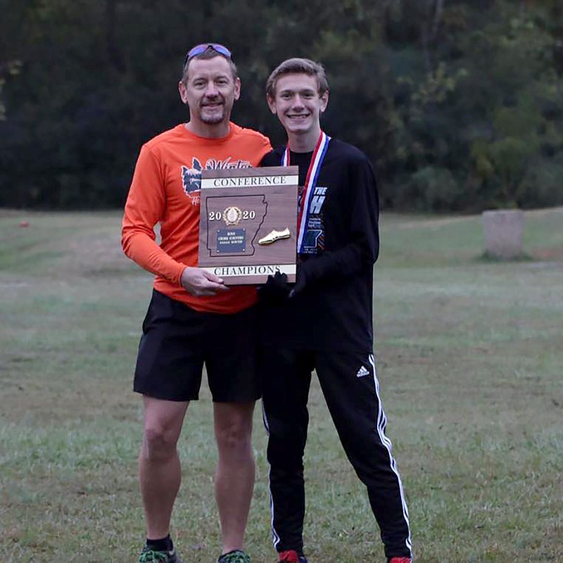 Jason Armitage, left, celebrates with his son Evan after Lake Hamilton won the Class 5A state cross country title at Oaklawn. Jason Armitage recently won the Road Runners Club of America 2021 National Outstanding Volunteer of the Year award. - Submitted photo