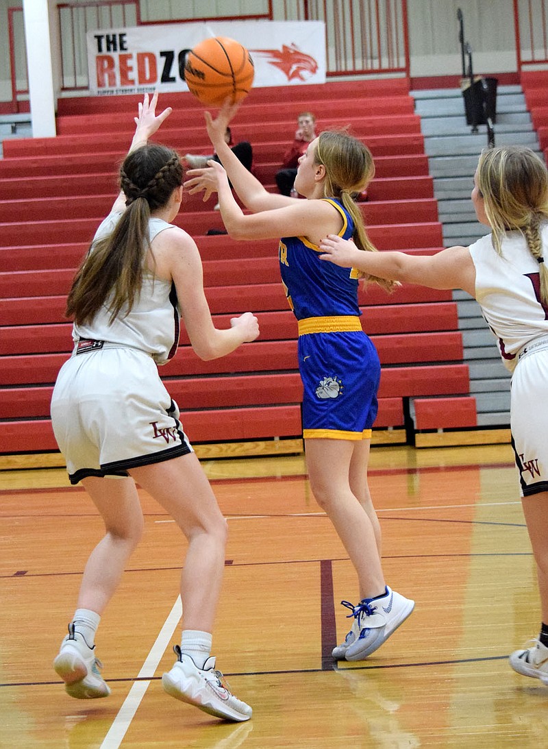 Westside Eagle Observer/MIKE ECKELS
Kaitlyn Funk (center) puts up a shot from the free-throw line during the third quarter of the Decatur-Life Way Christian varsity girls basketball contest at Bobcat Gym in Flippin Feb. 14. Playing in the first round of the 2A Region 1 district tournament, the Lady Warriors secured the win 46-18 and ended the Lady Bulldogs 2021-22 basketball season.