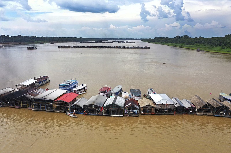 FILE - Dredging barges operated by illegal miners converge on the Madeira river, a tributary of the Amazon River, searching for gold, in Autazes, Amazonas state, Brazil, Nov. 25, 2021. Brazil's President Jair Bolsonaro has issued two decrees to drive gold prospecting with a focus on the Amazon rainforest, according to the texts published Monday, Feb. 14, 2022 in the official gazette. (AP Photo/Edmar Barros, File)