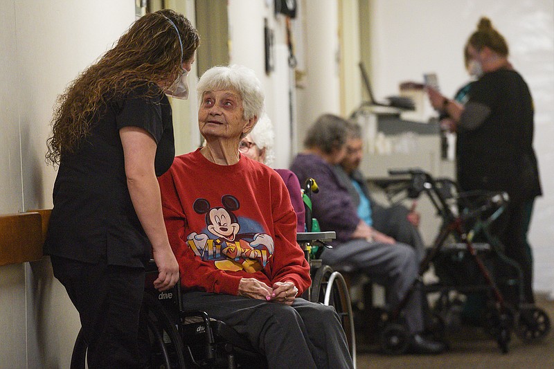 Ashley Powers (left), certified nursing assistant, visits with resident Doris Strovers on Thursday, Feb. 17, 2022, at the Greenhurst Nursing Center in Charleston. Visit nwaonline.com/220220Daily/ for today's photo gallery.
(NWA Democrat-Gazette/Hank Layton)