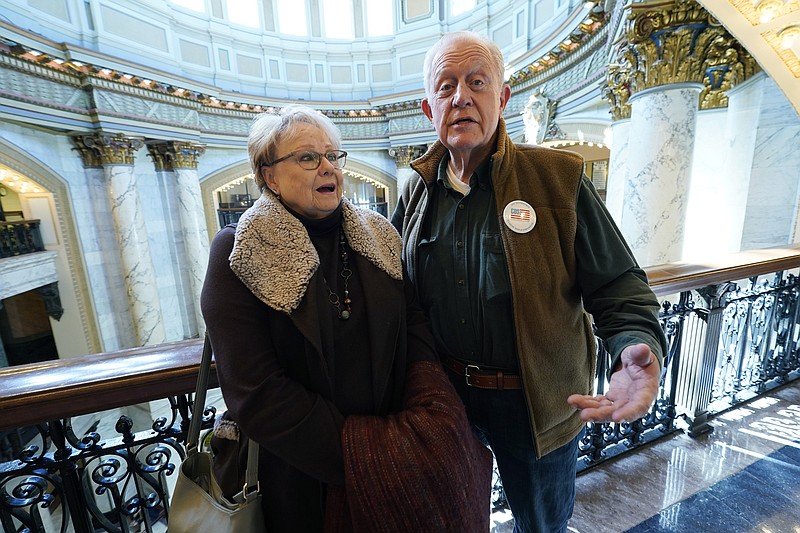 Married couple Les and Amanda Jordan of Summit, Miss., both retired, stand near the rotunda of the Mississippi Capitol in Jackson, Miss., Jan. 27, 2022. Amanda Jordan says legislative proposals to reduce or eliminate the state income tax could influence young people's decisions about whether to live in Mississippi, and Les Jordan says he's concerned that reducing tax collections could hurt poor people by limiting government services. (AP Photo/Rogelio V. Solis)