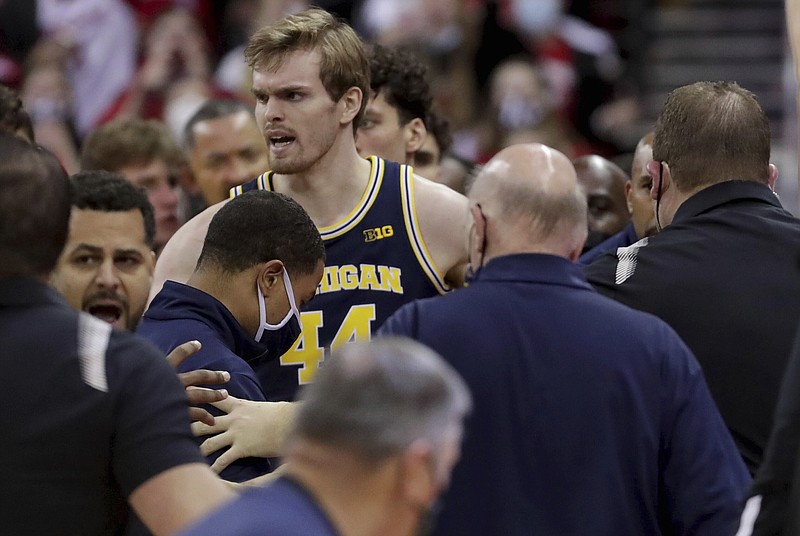 Wisconsin head coach Greg Gard, right, is involved in a scuffle with Michigan head coach Juwan Howard during the waning moments of an NCAA college basketball game Sunday, Feb. 20, 2022, in Madison, Wis. (Mark Hoffman/Milwaukee Journal-Sentinel via AP)