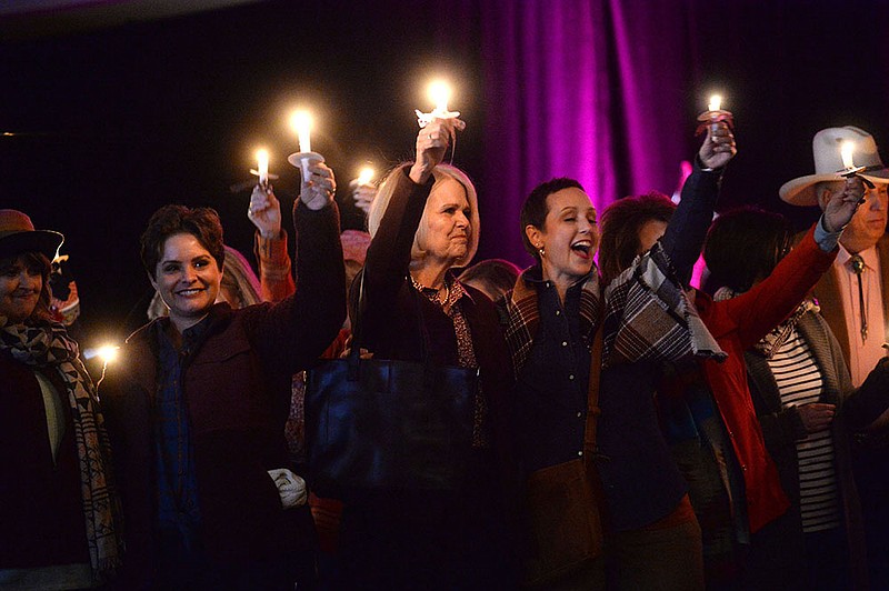 NWA Democrat-Gazette/ANDY SHUPE
Breast cancer survivors hold candles Wednesday, Oct. 23, 2019, as they take part in a candlelight recognition for survivors during the annual Susan G. Komen Ozark Pink Ribbon Luncheon at the Northwest Arkansas Convention Center in Springdale. Visit nwadg.com/photos to see more photographs from the luncheon.