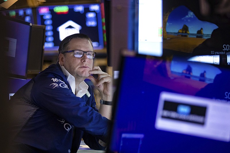In this photo provided by the New York Stock Exchange, specialist Gregg Maloney works at his post on the trading floor, Tuesday, Feb 22, 2022. Stocks shifted between small gains and losses in morning trading on Wall Street Tuesday as tensions escalated in Ukraine over Russia's decision to send forces into that nation's eastern regions. (Allie Joseph/New York Stock Exchange via AP)