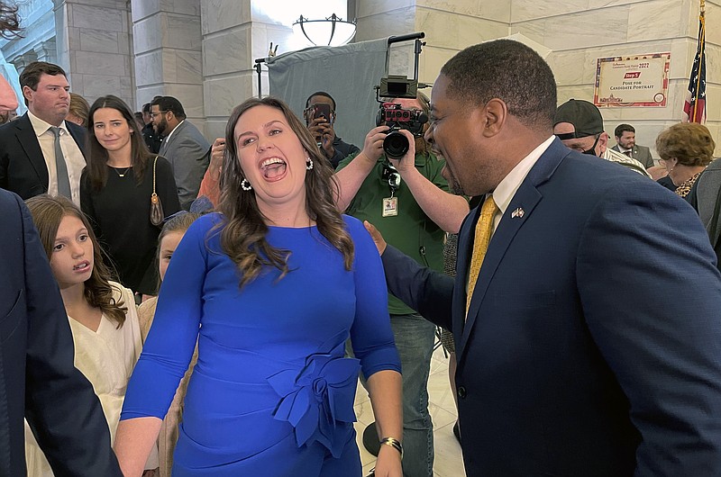 Sarah Sanders and Chris Jones talk at the Arkansas state Capitol in Little Rock, Ark. on the first day of candidate filing on Tuesday Feb. 22, 2022. Sanders filed to run for the Republican nomination for governor and Jones filed to run for the Democratic nomination. (AP Photo/Andrew DeMillo)