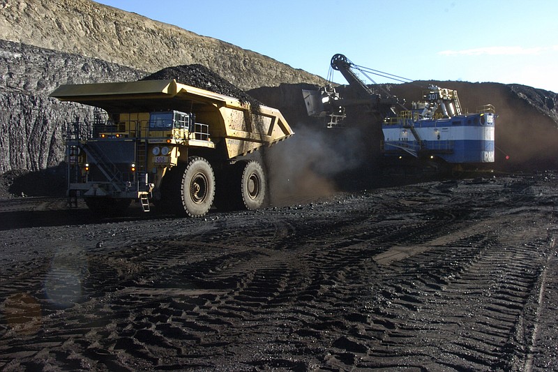 In this Nov. 15, 2016 photo, a haul truck with a 250-ton capacity carries coal after being loaded from a nearby mechanized shovel at the Spring Creek strip mine near Decker, Mont. The mine is in the Powder River Basin of Montana and Wyoming, the largest source of coal in the U.S. Environmentalists are pushing to end mining because emissions from burning coal help drive climate change. (AP Photo/Matthew Brown)