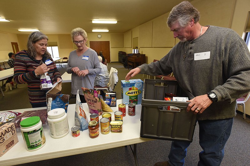 Eric Burton sets out samples of food on Saturday Feb. 12 2022 at that may be suitable for people dealing with Alpha Gal syndrome, which can be contrated from a tick bite. Alpha Gal Encouragers helps people deal with the affliction.
(NWA Democrat-Gazette/Flip Putthoff)