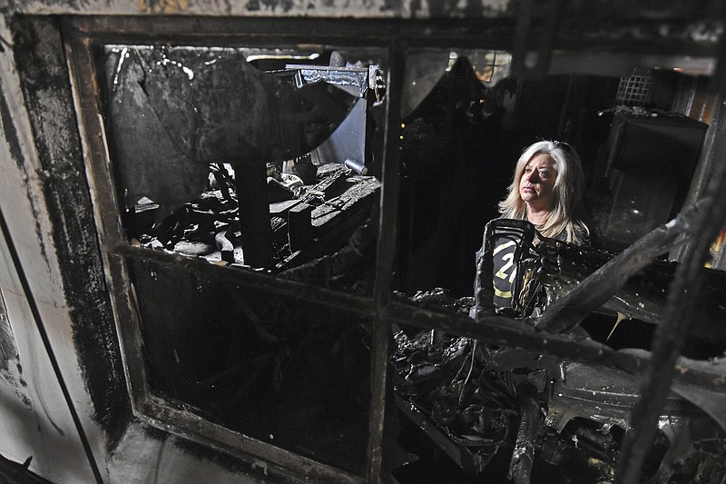 Jennifer Williams, a three-year volunteer for Cockrill's Country Critters, looks around the reptile room Friday, Feb. 25, 2022, where a fire started before spreading through the rest of the exotic barn Thursday in Austin. (Staci Vandagriff/The Arkansas Democrat-Gazette via AP)
