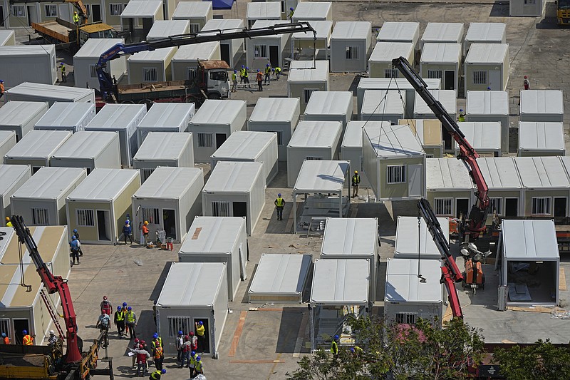 An aerial view shows a construction site of a new makeshift COVID-19 hospital and isolation facilities, in Tsing Yi of Hong Kong, Saturday, Feb. 26, 2022. For two years, Hong Kong successfully insulated most of its residents from COVID-19 and often went months without a single locally spread case. Then the omicron variant showed up. The fast-spreading mutation breached Hong Kong&#x2019;s defenses and has been spreading rapidly through one of the world&#x2019;s most densely populated places. (AP Photo/Kin Cheung)